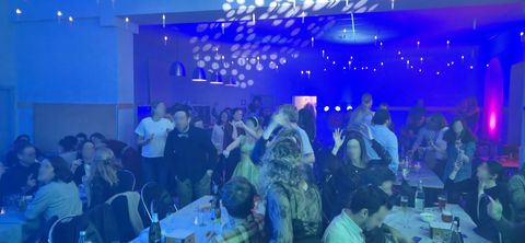 Soirée quiz à Gistoux : une salle remplie de tables d'équipes, éclairée en bleu